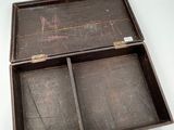 a wooden box with two compartments on a white surface