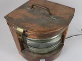 a small wooden box with a metal handle on a white surface