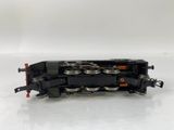 a small black train on a white surface