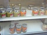 many cans of canned food on display in a glass case