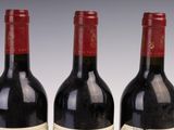 three bottles of wine sitting next to each other on a table