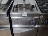 two deep fryers on the stove in the kitchen