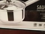packaging of a saucepan with a lid and a spoon in a store