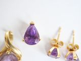 three pairs of amethe earrings and a pair of amethe earrings