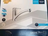 une boîte sur laquelle figure l'image d'un robinet de cuisine