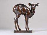 bronze sculpture of a deer standing on a wooden base