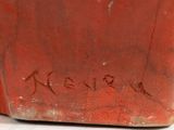 a red vase with writing on it sitting on a table