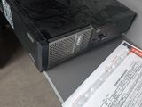 a black box sitting on top of a desk next to a paper
