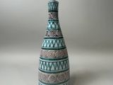 a blue and white vase sitting on a white surface