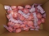 a cardboard box filled with lots of pink candies
