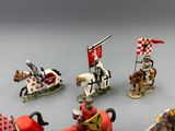 many figurines of knights riding horses and holding flags