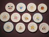 many plates with different designs on them on a table