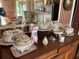 a large collection of china on a table in a room