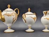 three white and gold vases with gold decorations on them