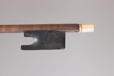 un gros plan d'un archet de violon dont l'extrémité est surmontée d'un bâtonnet en bois