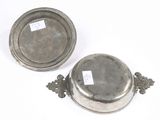 pair of silverplated dishes with handles and handles on a white surface
