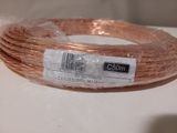 a roll of copper wire wrapped in plastic on a table