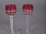 pair of red wine glasses on a grey background