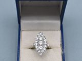 a close up of a diamond ring in a blue box on a table