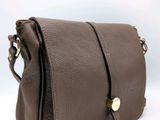 a close up of a brown purse on a white background