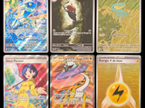 many cards of different colors and designs on a black background
