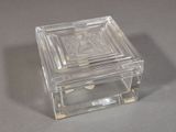 a glass box with a picture on it on a table