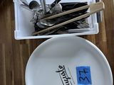 a white plate with spoons and forks on it