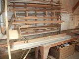 a room filled with lots of wooden furniture and tools