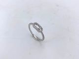 a close up of a diamond ring on a white surface