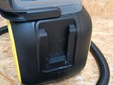 a black and yellow blow dryer sitting on a wooden floor