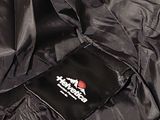 a black jacket with a red and white logo on it