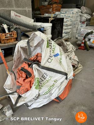 a pile of garbage in a garage with a hose