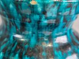 a blue vase that is sitting on a table
