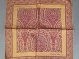 a close up of a pink and yellow paisley print handkerchief