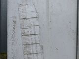a picture of a white refrigerator with a ladder sticking out of it ' s door