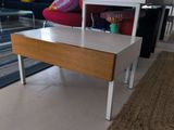 a coffee table with a drawer on it in a living room