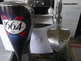 a beer glass and a spoon sitting on a counter