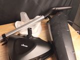a black and silver vacuum sitting on a wooden table