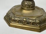 a gold candle holder with a bird on top