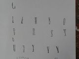 a piece of paper that has a drawing of letters and numbers on it