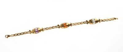 BRACELET en or jaune 750 °/°° à décor de trois bonbons" orné…