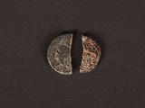 two coins are shown side by side on a black surface