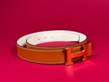 a brown and white belt on a pink background