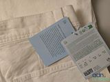 a white bag with a ticket and a card on it