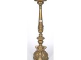 a brass candle holder with a candle on top of it