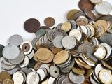 a pile of coins sitting on a white surface