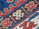 an image of a close up of a rug with a red and blue design