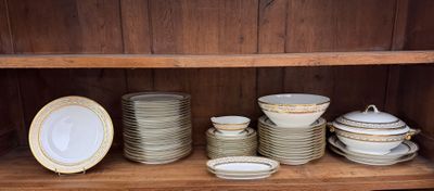 many plates and bowls on a shelf in a cabinet