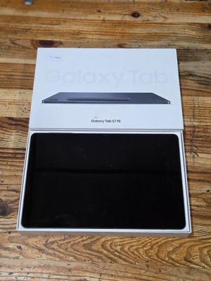 the box is open on a wooden table with a laptop in it