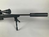 a rifle on a tripod with a scope on it